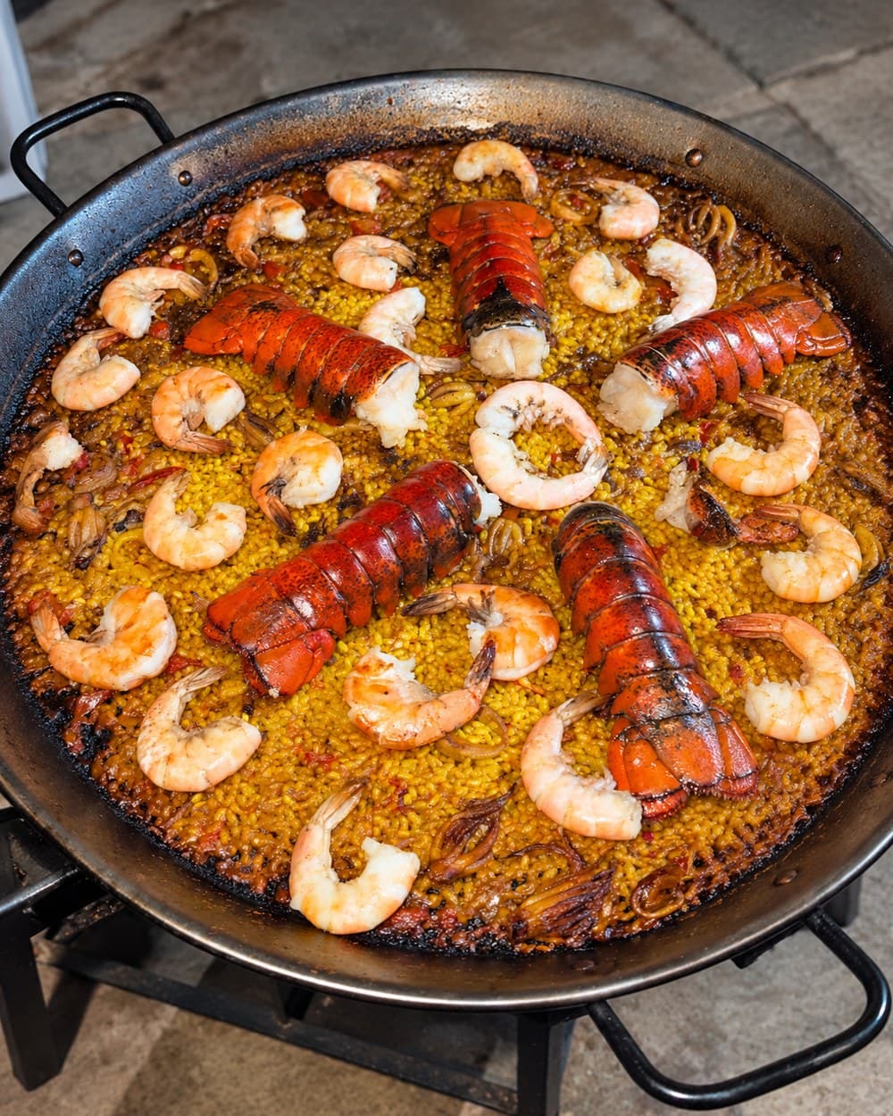 Paella with whole lobster at the center of the pan