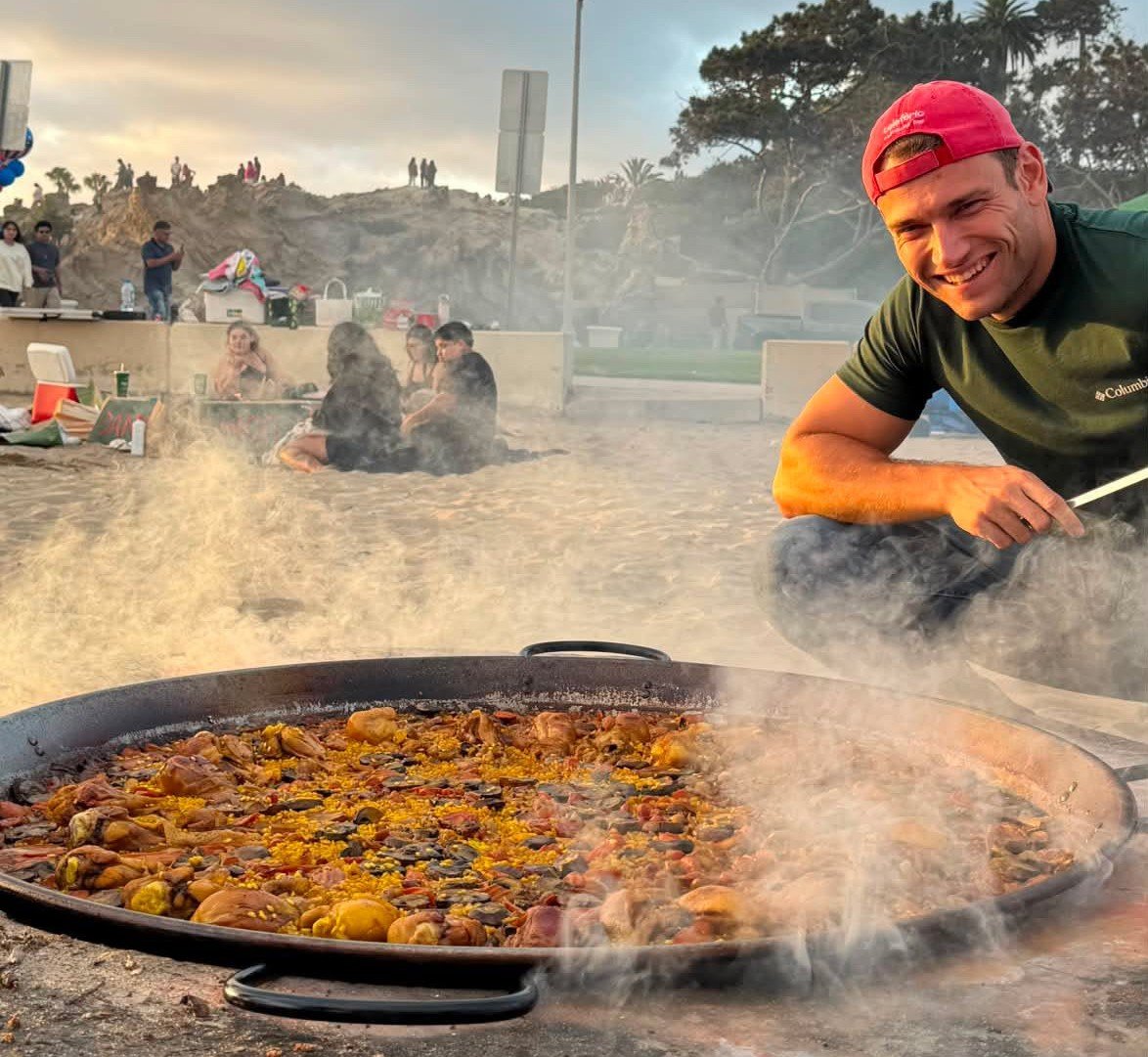 Pau cooking a paella on the beach